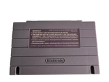 an old nintendo game console sitting on top of a white surface