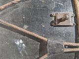 a large metal drum with a rope around it