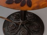 a table that has a lamp on it with a flower design on it