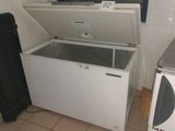 a refrigerator and a freezer in a small room