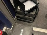 a suitcase with a laptop on top of it in a room
