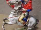a figurine of a man riding a horse on a table