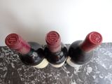 three bottles of wine that are sitting on a table