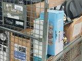 a metal cage with a bunch of items inside of it