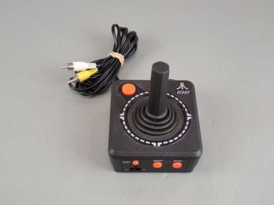a video game controller sitting on a table next to a charger