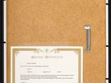 a black frame holds a certificate on a cork board
