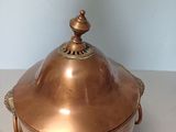 brass plated bowl with a lid and handles on a table