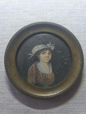 an old picture of a woman in a hat and striped dress