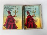 pair of vintage matchboxes depicting a woman in a red dress and a man in a red coat