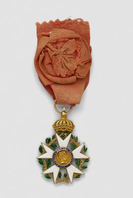 an image of a gold medal with a rose on it