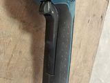 a blue cordless drill on a wooden surface