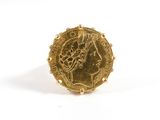 an image of a gold ring with a coin on it