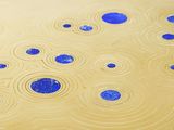 a gold plate with blue dots on it