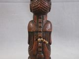 a wooden statue of a woman holding a baby in her arms