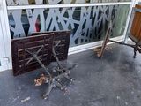 a broken chair on the sidewalk outside of a building