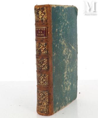 an old book sitting on top of a white table next to a white wall