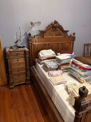 a bed that has a lot of books on top of it