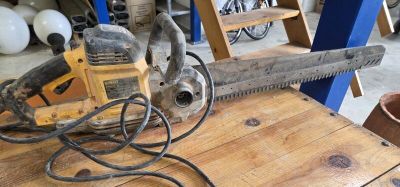 someone is using a chainsaw to cut a piece of wood on a table