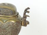 a small bronze incense pot with a bird on it