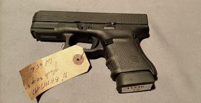 a gun that is on a table with a price tag