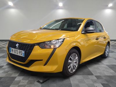 a yellow car parked in a garage with a checkered floor