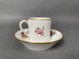 a close up of a cup and saucer on a table