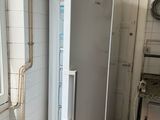 an image of a refrigerator in a kitchen with a window