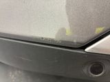 a close up of a car ' s bumper with a small hole in it