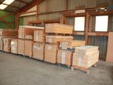 many stacks of wood in a warehouse with a lot of pallets