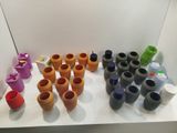 many different colored pots on a white shelf next to each other
