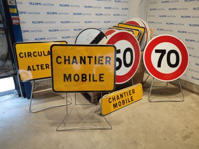 three signs that are sitting on the ground next to each other