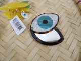 a picture of a blue and white eye shaped object on a table