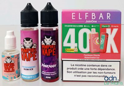 deux flacons de liquide et une boîte d'e-liquide posés sur une table