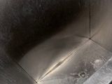 a stainless steel sink in the middle of a bathroom