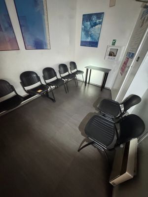 several chairs are lined up in a row in a waiting room