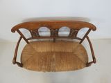 an image of a wooden chair with a wicker seat and back rest