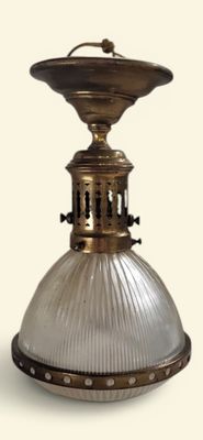 une lampe à l'ancienne munie d'un abat-jour en verre