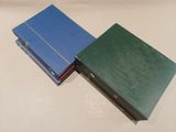 two blue and green books sitting on top of a white table