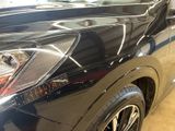 a close up of a black car with chrome trims