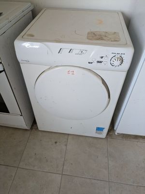 two washers and a dryer in a small room