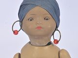 a small doll with a turban on it ' s head