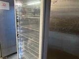 a refrigerator that is sitting in a kitchen next to a refrigerator