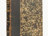an old book sitting on top of a table next to a white background