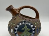 a brown vase with a blue and green design on it