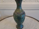 a blue vase sitting on top of a white table