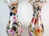 two vases sitting side by side on a white surface