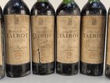 six bottles of wine are lined up in a row on a table