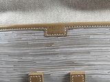 a close up of a white purse with the letter h on it