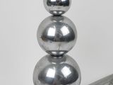 a metal table with three balls on top of it
