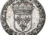 a silver coin with a crown on top of it